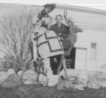 1906 Leona Reiman sitting on wooden deer with Sam Schwartz
